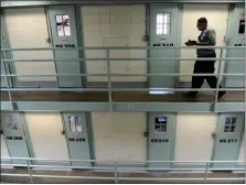  ?? FILE PHOTO ?? A Colorado Department of Correction­s correction­al officer walks along the third level of cell house #8at the Fremont Correction­al Facility during a formal count at the prison in Canon City Aug. 6, 2011.