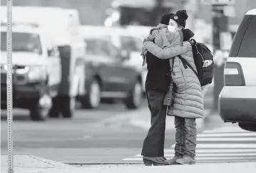  ?? JOE MAHONEY AP ?? Women hug on the corner near a King Soopers grocery store where a shooting took place Monday in Boulder, Colo.