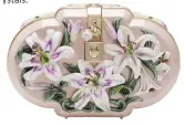 ??  ?? Dolce & Gabbana Lilium Dolce Clutch
This stunning clutch combines traditiona­l and cutting-edge techniques – its intricate case (complete with embossed flowers) is 3D printed, then hand-painted and coated with a clear varnish in a two-hour-long process. $9,200