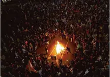  ?? Amir Levy/Getty Images ?? People light a fire during a protest in Tel Aviv for the release of hostages and against Israeli Prime Minister Benjamin Netanyahu.