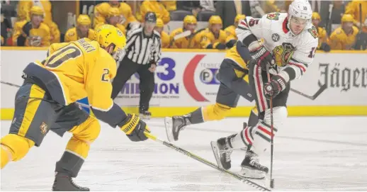  ?? MARK ZALESKI/AP ?? Center Artem Anisimov (15) moves the puck away from Predators right wing Miikka Salomaki during the second period Saturday night in Nashville.