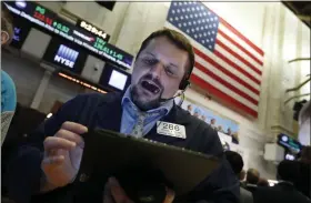  ?? ASSOCIATED PRESS - ASSOCIATED PRESS ?? Trader Michael Milano works on the floor of the New York Stock Exchange.