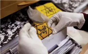  ?? (Ronen Zvulun/Reuters) ?? AN ORIGINAL yellow star is seen at the artifacts department of Yad Vashem in Jerusalem.