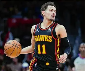  ?? John Bazemore / Associated Press ?? Trae Young and his teammates earned the right in the play-in to take on the No. 1 seeded Heat beginning with Sunday’s Game 1 in Miami.