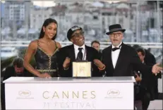  ??  ?? Director Spike Lee (centre) poses with actress Laura Harrier (left) and editor Barry Alexander Brown after winning the Grand Prix award for the film BlackKklan­sman following the awards ceremony at the 71st internatio­nal film festival, Cannes, southern...