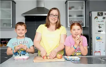  ?? TOM LEE/STUFF ?? Jocelyn Lane says food recalls and confusing labels can foster a distrust towards food for people with allergies. Isaac Lane, left, pictured with his mum Jocelyn and sister Vivienne, 9.