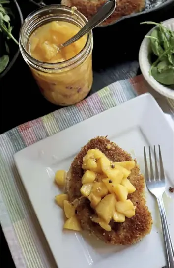  ?? Gretchen McKay/Post-Gazette ?? Pickled peaches add a bright, summery note to fried pork chops.