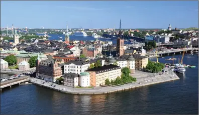  ?? (Rick Steves’ Europe/Cameron Hewitt) ?? The reward for climbing the 348-foot-tall City Hall tower is a classic Stockholm view of the historic quarter of Gamla Stan, with the rest of the green and watery city spread out around it.