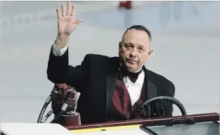  ?? CLIFFORD SKARSTEDT EXAMINER ?? Retiring Zamboni driver Gary "Booter" Parnell gestures to the crowd following a pre-game ceremony Saturday.