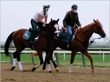  ?? AP PHOTO BY SETH WENIG ?? Belmont Stakes hopeful Robin Smullen on Tiz the Law, left, is led around the track by trainer Barclay Tagg during a workout at Belmont Park in Elmont, N.Y., Friday, June 19.