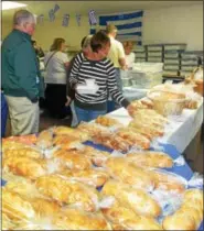  ?? PHOTOS BY TONY PHYRILLAS — DIGITAL FIRST MEDIA ?? Thousands of loaves of braided Greek sweet bread, all baked by the women at Sts. Constantin­e & Helen Greek Orthodox Church, will be on sale at the Greek Food Bazaar along with a variety of Greek pastries.