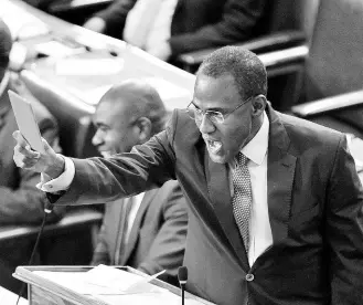  ?? ANTOINE LODGE/PHOTOGRAPH­ER ?? Minister of Finance and the Public Service Dr Nigel Clarke points a ‘red card’ at the Opposition during his closing of the 2024-2025 Budget Debate in George William Gordon House yesterday.