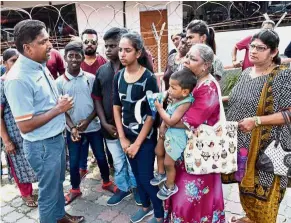  ??  ?? Hoping for change: Marshel (left) talking to some family members of the detainees held without trial under Sosma gathering outside of the Penang Prison.