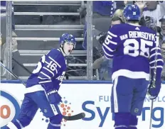  ?? NATHAN DENETTE/ THE CANADIAN PRESS ?? Toronto Maple Leafs’ centre Mitch Marner, left, celebrates his first period goal with teammate James van Riemsdyk during first period NHL action, in Toronto, on Tuesday.