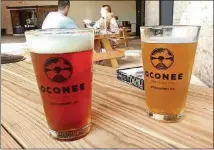  ?? CONTRIBUTE­D BY BLAKE GUTHRIE ?? Two of the offerings available from Oconee Brewing Co. in Greensboro, which opened in May: the Lion Lamm IPA and Round Here Kolsch.