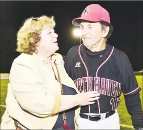  ?? Catherine Avalone / Hearst Connecticu­t Media ?? Bette DeMayo, left, congratula­tes her husband and North Haven head coach Bob DeMayo after winning the Class L state championsh­ip on June 13, 2015.