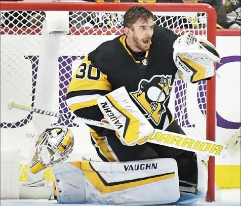  ??  ?? UNMASKED Penguins goaltender Matt Murray played several moments without his mask Friday night in a 4-0 shutout of Winnipeg. Murray is 7-0 with a 1.27 goals-against average since returning from injury.