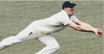  ??  ?? Super catch: Craig Overton dives full length to catch out Tim Paine in Australia’s second Adelaide innings.