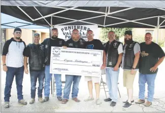  ?? Brodie Johnson • Times-Herald ?? The Valhalla chapter of the Punishers Motorcycle Club held a Poker Run fundraiser on Saturday to help injured Forrest City Police Detective Eugene Watlington with medical bills and other expenses. Pictured from left, Andy Wizer, Everett Tucker, Jeff Norris, Wesley Mason, Watlington, Jason Wizer, Scott Martin and Jeff Simpson.