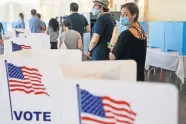  ?? [ELIJAH NOUVELAGE/GETTY IMAGES] ?? People wait in line to vote in Georgias Primary Election on June 9 in Atlanta.