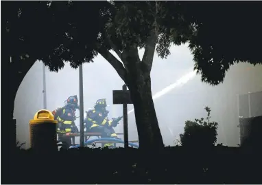  ??  ?? KARLMONDON/STAFF PHOTOS Firefighte­rs battle a smoky, four-alarm fire at the Millbrae Community Center Thursday morning.