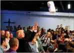  ??  ?? Trump throws paper towels to storm victims.