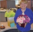  ?? PentictonH­erald ?? JAMES MILLER/
Linda Tennant opens gifts recognizin­g her 50 years of service at the Herald.