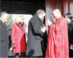  ??  ?? FRENCH PRESIDENT Emmanuel Macron and his wife Brigitte Macron are greeted by a monk during a visit at the Big Wild Goose Pagoda in the northern Chinese city of Xian, Shaanxi, China, Jan. 8.