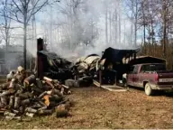  ?? (Photo by Ryan Phillips, SDN) ?? A house fire on Oliver Jackson Road - a dirt road in Oktibbeha County - was still smoldering around noon on Wednesday