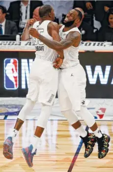  ?? THE ASSOCIATED PRESS ?? Golden State’s Kevin Durant, left, celebrates with Cleveland’s LeBron James during the all-star game on Sunday. The Warriors and Cavaliers are two of the favorites as the NBA season heads down the stretch.