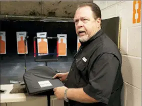  ?? MICHAEL WYKE — THE ASSOCIATED PRESS ?? Steve Naremore, founder and CEO of TuffyPacks, handles one of his bulletproo­f panels that can be inserted into various makes and sizes of backpacks before a shooting demonstrat­ion of the stopping ability of the product at the Shiloh Shooting Range, Friday in Houston.
