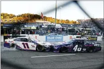  ?? WADE PAYNE — THE ASSOCIATED PRESS ?? Denny Hamlin (11) prevents Alex Bowman (48) from doing a celebrator­y burnout Sunday’s NASCAR Cup Series race in Martinsvil­le, Va.