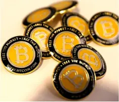  ??  ?? File photo shows Bitcoin.com buttons are seen displayed on the floor of the Consensus 2018 blockchain technology conference in New York City. — Reuters photo