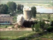  ?? APTN — THE ASSOCIATED PRESS FILE ?? FILE- In this file image from TV, the demolition of the 60-foot-tall cooling tower at its main reactor complex in Yongbyon North Korea.