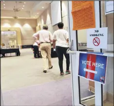  ??  ?? Voters in Stonecrest select a mayor and City Council at the New Birth Missionary Baptist Church polling location during Tuesday’s election. Jason Lary was elected the new city’s first mayor. Other races in Stonecrest and South Fulton, another new city,...