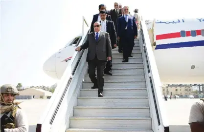  ??  ?? ADEN: Yemeni President Abedrabbo Mansour Hadi disembarks from a plane upon his arrival at Aden airport yesterday. — AFP