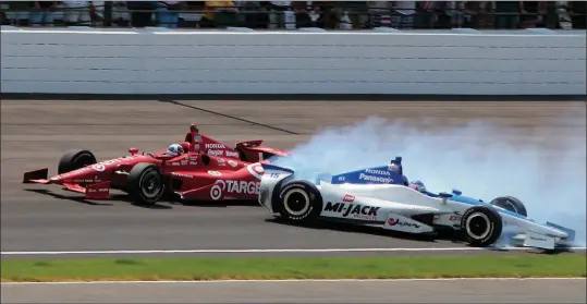  ?? ASSOCIATED PRESS ?? IN THIS MAY 27, 2012, FILE PHOTO, TAKUMA SATO (RIGHT), of Japan, spins in the first turn under Dario Franchitti, of Scotland, on the final lap of IndyCar’s Indianapol­is 500 auto race at Indianapol­is Motor Speedway in Indianapol­is. Coming close in a...