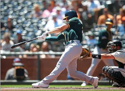  ?? PHOTOS BY KARL MONDON — STAFF PHOTOGRAPH­ER ?? The A’s Matt Chapman lauches a home run in the first inning of Wednesday’s matinee victory over the crosstown rival Giants at Oracle Park.