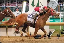  ?? AP PHOTO/MARK HUMPHREY ?? Rich Strike, with jockey Sonny Leon aboard, crosses the finish line to win the Kentucky Derby on Saturday at Churchill Downs in Louisville, Ky. Rich Strike was a long shot at 80-1 odds and pulled off the secondbigg­est upset in the race’s 148-year history.