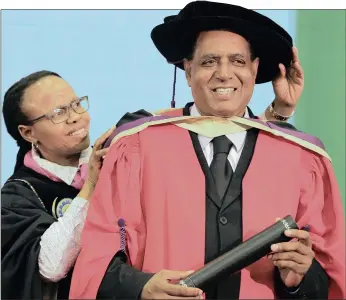  ?? PICTURE: GCINA NDWALANE ?? Environmen­tal activist Desmond D’sa receives his honorary doctorate from Professor Thenjiwe Meyiwa at the Durban University of Technology yesterday.