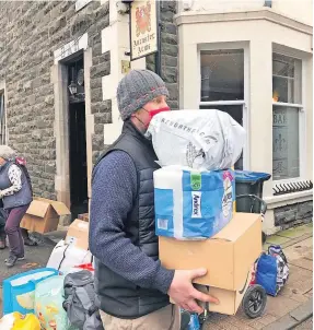  ?? ?? Lending a hand Iain Hansen loading up from the Comrie collection point at the Ancaster Arms