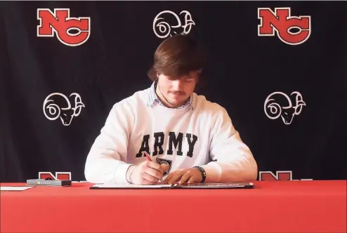  ?? Dave Stewart / Hearst Connecticu­t Media ?? New Canaan’s Ned Brady signs his National Letter of Intent to play football for Army during a ceremony in New Canaan’s Waveny House on Wednesday.