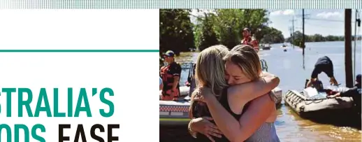  ?? EPA PIC ?? A woman and her daughter hug after being reunited following an evacuation in Windsor, outside Sydney, Australia, yesterday.