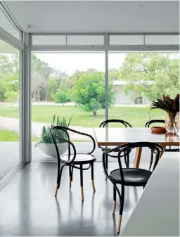  ??  ?? DINING ROOM With the couple’s grown-up brood only 15 minutes’ drive away, Sundays are for family gatherings and tucking into a meal around the hand-crafted oak dining table by Revival Furniture in Western Australia. Cleverly, the couple has an identical table outside, which can be joined to the inside one to feed a larger crowd. “When the extended family are here there are 18 of us, so it’s perfect,” explains Jappalin.