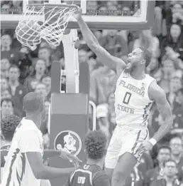  ?? MARK WALLHEISER/AP ?? FSU forward Phil Cofer, who finished with seven points, turns a rebound into a dunk in the first half Wednesday night in Tallahasse­e. FSU won 68-62.