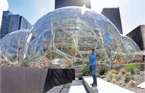  ?? ELAINE THOMPSON, AP ?? The tallest of the three interconne­cted spheres on the Amazon.com campus will be 90 feet high and 130 feet in diameter and is planned to include a botanic garden of waterfalls and treehouse-like spaces overlookin­g tropical gardens.