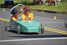 ?? MARIAN DENNIS – DIGITAL FIRST MEDIA ?? Kids zoomed down Wilson Street Saturday during the Soap Box Derby Challenge race. Children with special needs were given the opportunit­y to compete with a co-driver in a race similar to the Pottstown Soap Box Derby.