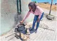  ?? ?? EVERITE resident Vuyelwa Mntubu uses a coal fire to boil water.