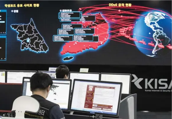  ?? YUN DONG-JIN/YONHAP VIA THE ASSOCIATED PRESS ?? Employees monitor electronic boards for possible ransomware cyberattac­ks at the Korea Internet and Security Agency in Seoul, South Korea, last Monday.