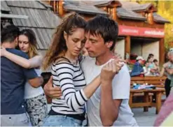  ??  ?? Montenegri­n Darko Dozic (rigt) dances tango with a partner during a Tango camp.